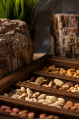 Mix of Nuts in a wooden box with stones for decor