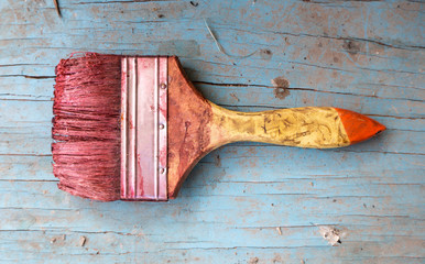 Paint brush placed on blue wooden floor