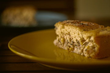 Chicken pie with light dough on a yellow plate