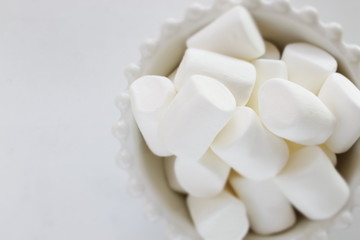 Marshmallow In bowl on white background with copy space