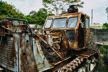 Old abandoned rusty broken tractor. Tractor in a landfill.