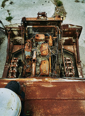 Old abandoned rusty broken tractor. Tractor in a landfill.