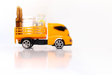 Pharmaceutical delivery of medical pills concept. Orange truck loaded with drugs, pills, bottles