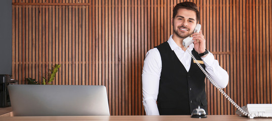 Receptionist talking on phone at desk in lobby. Banner design