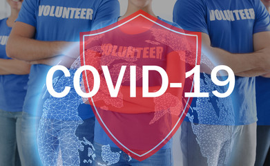 Volunteers uniting to help during COVID-19 outbreak, closeup. Shield and world globe illustrations...