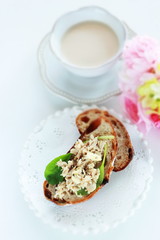 Tuna fish and baby leaves open sandwich for healthy breakfast