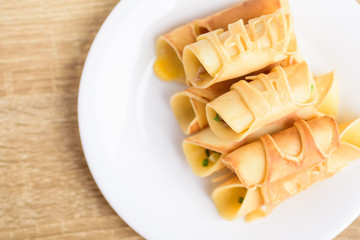 Thai dessert (Khanom Tokyo), pancake roll stuffed with minced pork on white plate