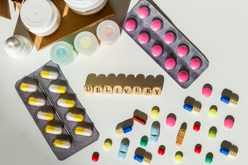 Delivery text surrounded by pills, blisters, medicine bottles