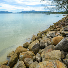 Rock beach and blue sky with beautiful clouds tropical sea
