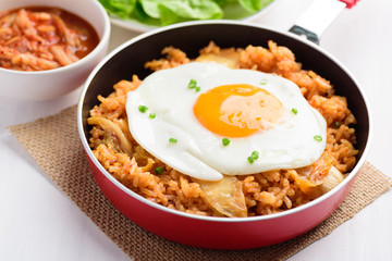 Kimchi fried rice with fried egg in small cooking pan, Korean food
