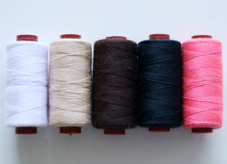 Various sewing yarns on white background.
