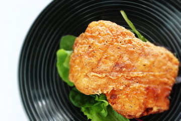 Fried chicken on white dish with copy space