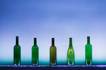 abstract empty wine bottles with blue led illumination