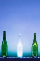 abstract empty wine bottles with blue led illumination