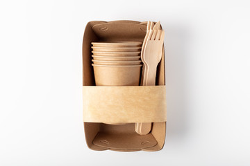 Organic eco packaging top view. Container, fork, knife and wooden Cup. On a white background