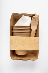 Organic eco packaging top view. Container, fork, knife and wooden Cup. On a white background