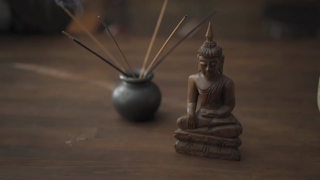 Decorative figurines and religious paraphernalia on the table at the business woman who works in the office. Prores 422. 