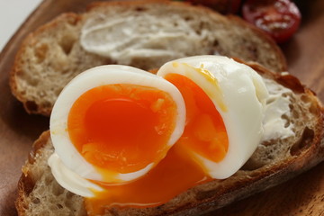 soft boiled egg on cream cheese toast for gourmet comfort breakfast