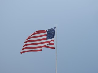 american flag on blue sky