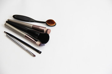  different makeup brushes on a white background close-up