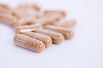 Herbal capsule, nutritional supplement, vitamin pill, herbal medicine on white background. Tribulus Terrestris