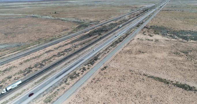 Stationary shot of cars and semis driving along i10