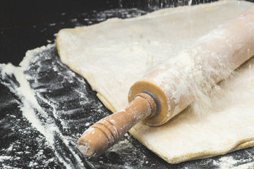 Dough with rolling pin and flour. pizza base preparing