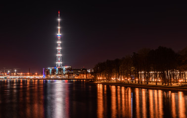 Fototapeta na wymiar TV tower with lights and the river in St. Petersburg at night.