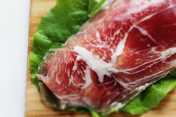 sliced ham on plate with copy space for gourmet