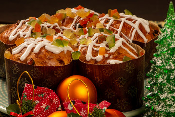 panettone topped with candied fruit and white chocolate sauce