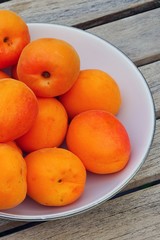 Bowl of fresh ripe orange apricots