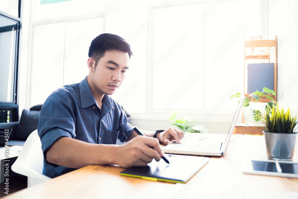 Fototapete Working from home web designing graphical user interface UX UI, home office using computer laptop and pen sketching graphics tablet device creative planning innovative ideas, asian man quarantine