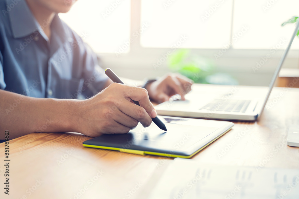 Fototapete Working from home web designing graphical user interface UX UI, home office using computer laptop and pen sketching graphics tablet device creative planning innovative ideas, asian man quarantine