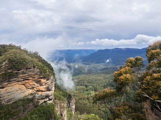 Clouds clear in a vista showing Blue Mountains in the distance. at Blue Mountain National Park, New South Wales, Australia