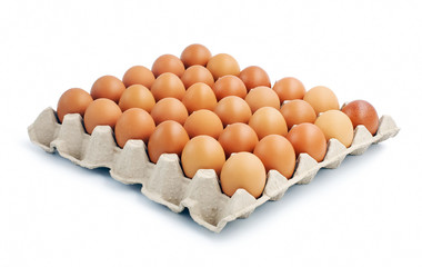 Brown chicken eggs laid on cardboard box isolated on white background.