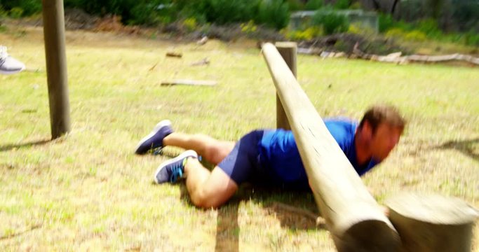 Military people jumping over the hurdles during obstacle course