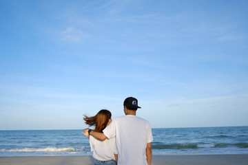 happy romantic wedding couple in love and look at the horizon with sunset