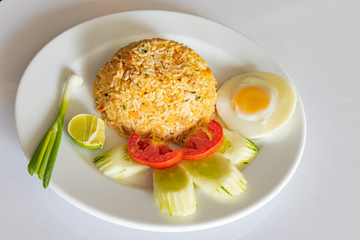 Pork fried rice, add eggs in a white dish