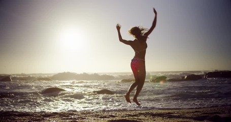 Woman jumping on the beach