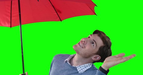 man with an umbrella raising hand on green background