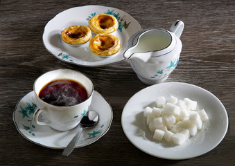 Hot tea style English and snack with sugar and fresh milk on gray wooden table