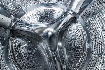 Drum of washing machine dry and clean close-up, inside view
