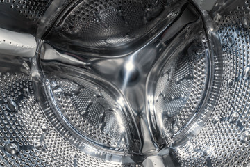 Drum of washing machine dry and clean close-up, inside view