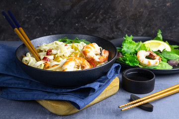 Stir fry noodles with vegetables and shrimps in bowl.
