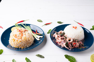 Fried rice with shrimp  and squid on the blue  dish on wooden table