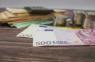 Euro banknotes on the background of a calculator and money. Business concept.