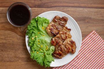 dish of teriyaki chicken with salad, corn and ssame seeds