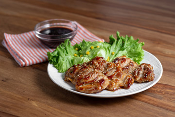 dish of teriyaki chicken with salad, corn and ssame seeds