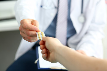 Medico giving pills to patient