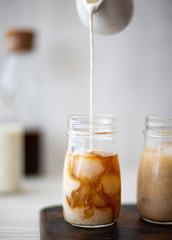 Iced coffee with cream in small bottles